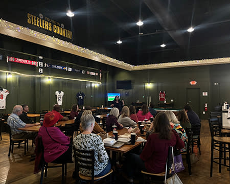 Members of the JoCo Hospitality Association listen to speaker and influencer NC Tripping about the advantages of marketing with social media.