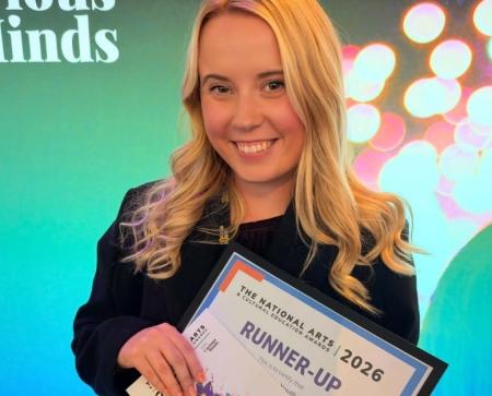Annabelle Lee stands with Runner up certificates for One to Watch category at awards