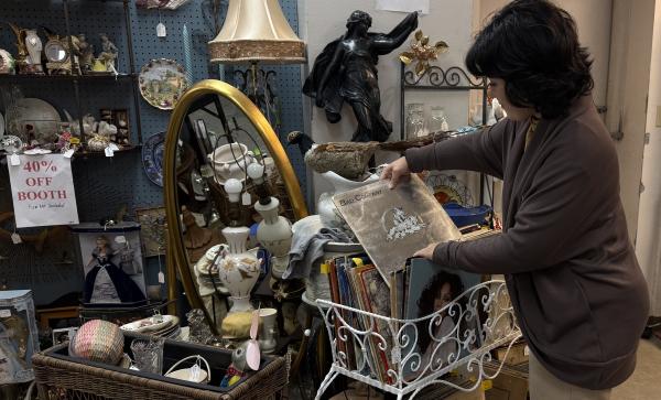 A customer browses a vinyl collection at Grand Antiques & Collectibles in Fort Smith, Arkansas