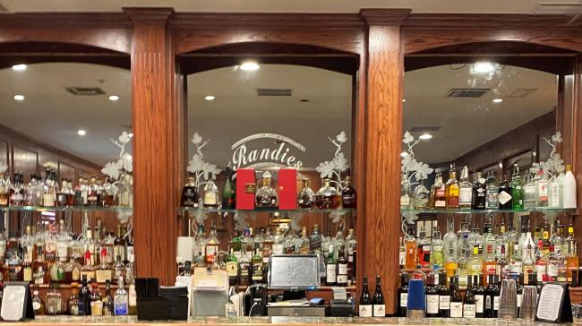 Bar with Randie's on the mirror behond bottles.