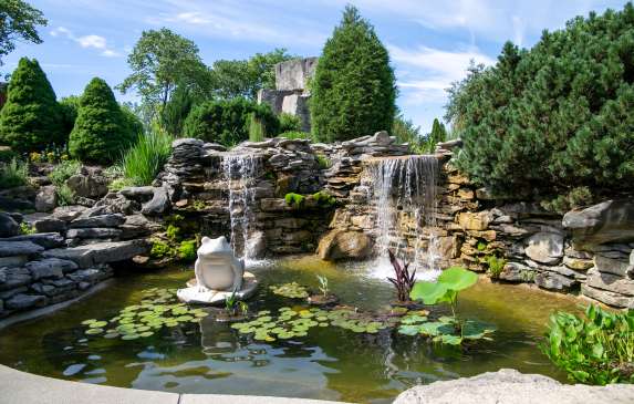 A garden pond with limestone rock and sculptures at Oliver Winery