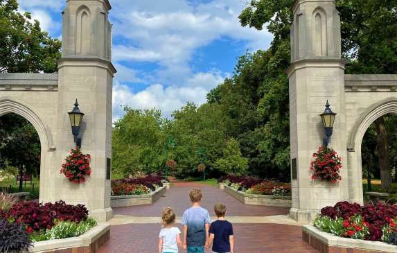 Three small kids holding hands at Sample Gates