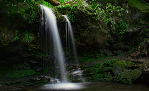 Water tumbles over cliffs into a pool at Grotto Falls in the Smoky Falls.