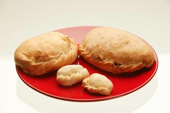 A plate with two regular sized and two mini pasties
