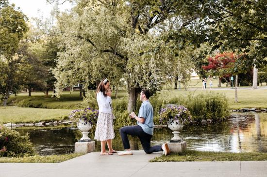 a man proposing to a woman in the greenery of Congress Park captured by Lizz Spano photography