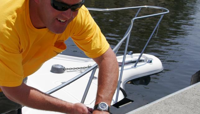 Man tying up his boat at the Great Bridge Lock tie up in Chesapeake, VA