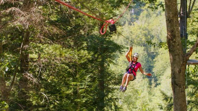 Alpine Adventures - Woman on Zipline in Forest