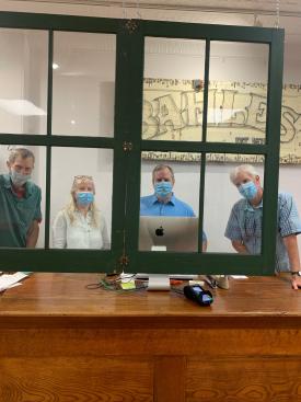 Bahle's used vintage windows instead of plexiglass to add a (creative, eye-catching!) layer of protection for customers and staff.  From left to right: Rich Bahle, April Gilbert, Chris Hufford and Chris Bahle