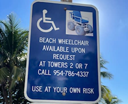 A Sign with information about how to request a beach wheelchair