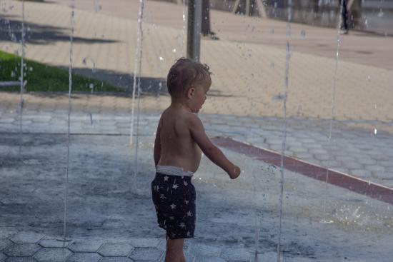 little boy playing in City Deck Splash Pad
