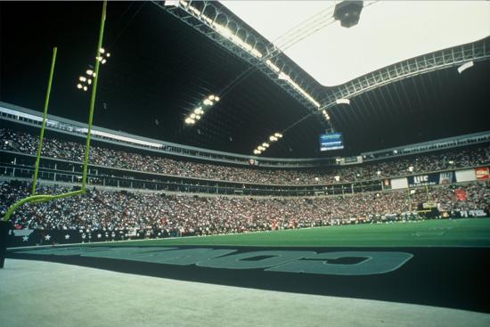 An interior shot of Texas Stadium full of fans and the open roof