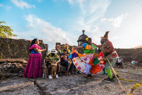 Colorful group of Afro-Congo dancers outside of Portobelo ruins fortress, Colon Province