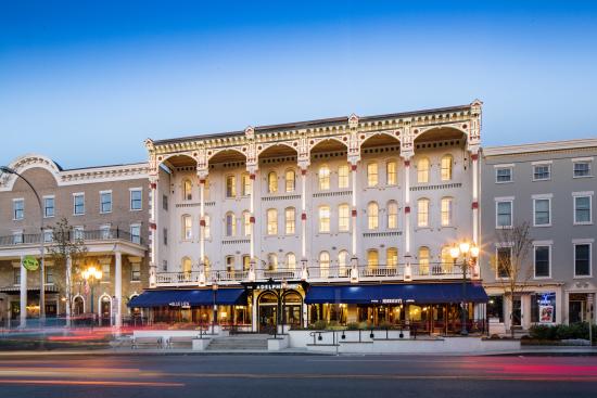 Adelphi Hotel at dusk with lights on
