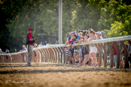 people standing on railing at Oklahoma Training Track