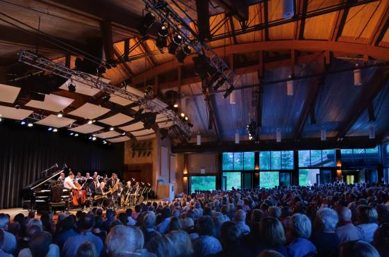 The facility's unique sliding glass panels capture the feeling of a summer night concert in a park.