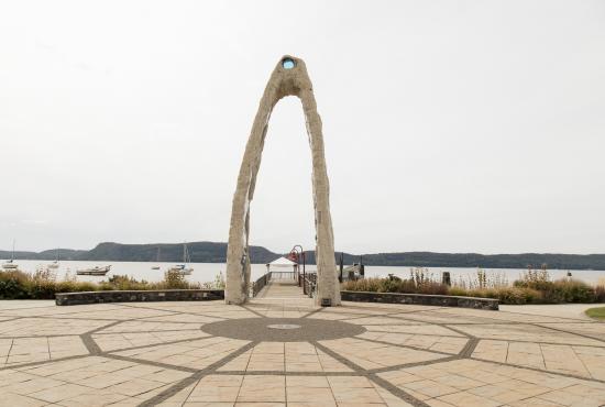 A piece of artwork in the shape of an arch sits beside the Hudson River at Henry Gourdine Park.