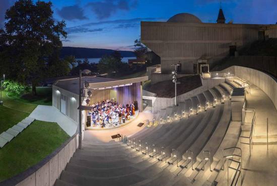 A band plays on the stage of the Hudson River Museum Amphitheater.