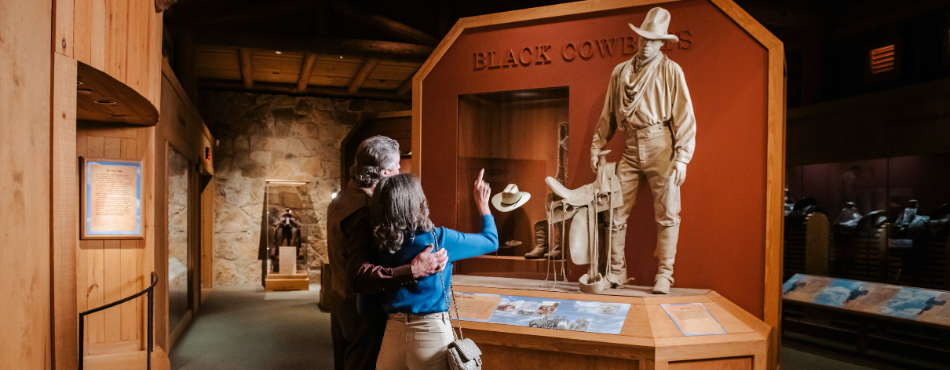 A couple looking at an exhibit at the Cowboy Museum