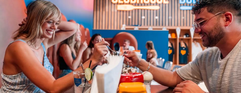 A couple sharing food at Curveball Kitchen