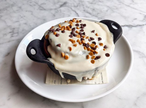 A sweet concoction in a mini dutch over filled with cream sauce and chocolate and peanut butter chips at Agricola Eatery
