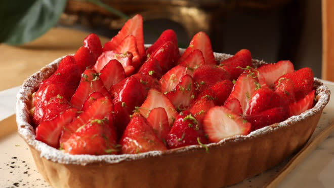 a heart-shaped strawberry tart on a plate