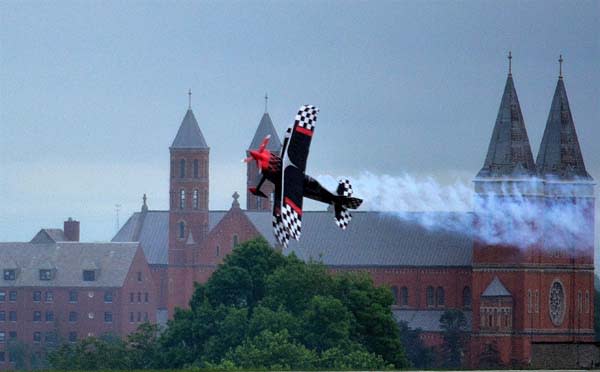 glider plane flying over building in downtown