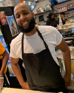 Chef and owner of Hoyo's Kitchen behind restaurant counter