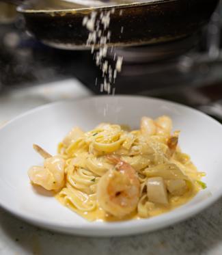 white plate with linguini pasta and shrimp