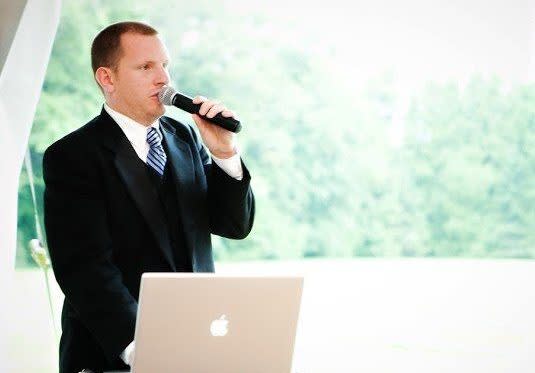 Wedding DJ with Microphone in Front of Laptop on Mackinac Island