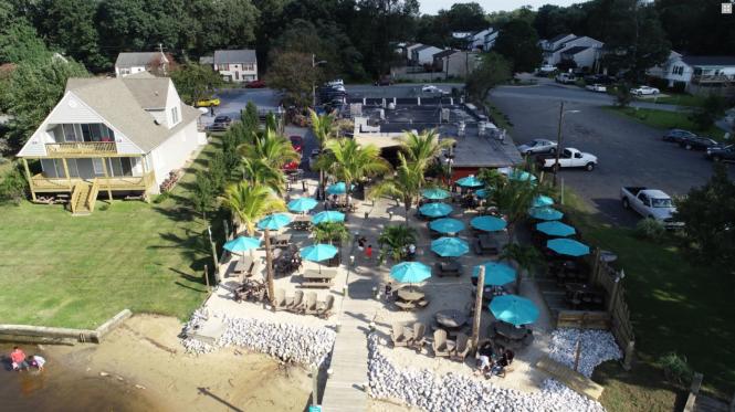 Rams Head Dockside aerial view with restaurant and outdoor patio.