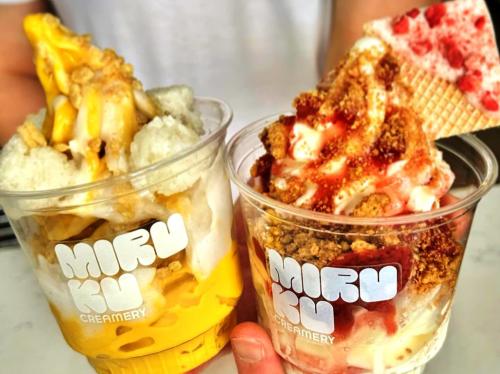two cups of soft serve ice cream with toppings