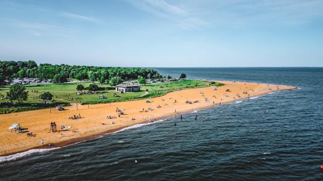 An aerial shot of a beach with water in the background