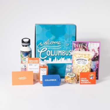 Columbus box with attraction tickets, gift cards, food items, water bottle, and Visitor guide
