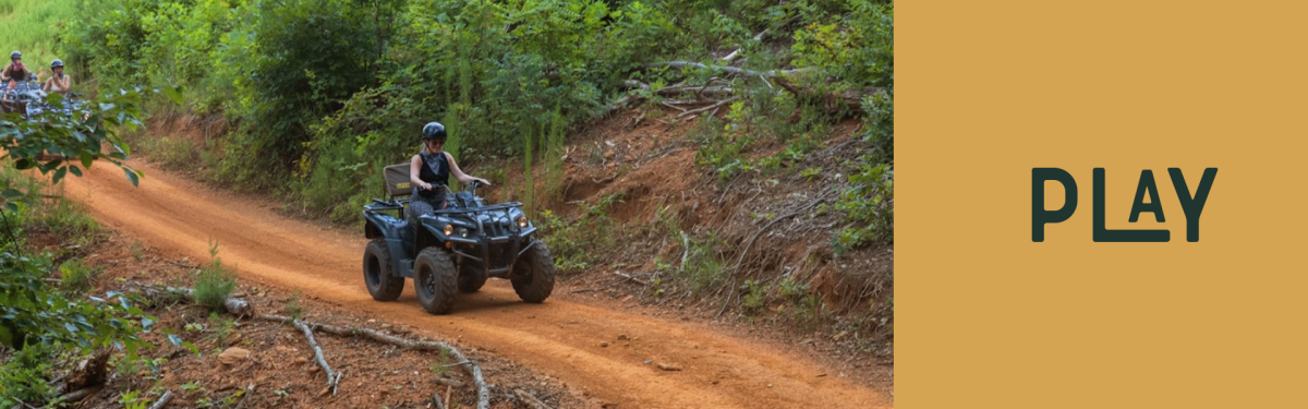A person riding through a lush trail in a forest on an ATV in Rutherford County, NC. 
