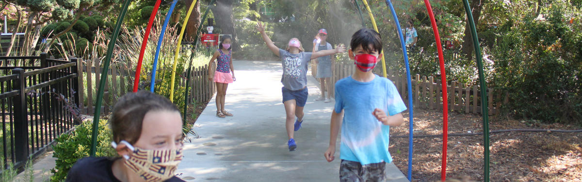 children enjoying misters at outdoor park