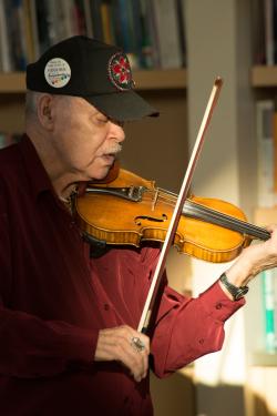 Bill Stevens playing the fiddle at the Morris Thompson Cultural and Visitors Center as part of the Festival of Native Arts.
