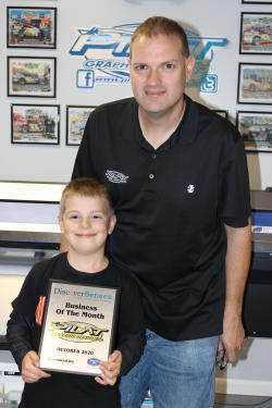 Dan Pilat and son posing with October 2020 Business of the Month Plaque