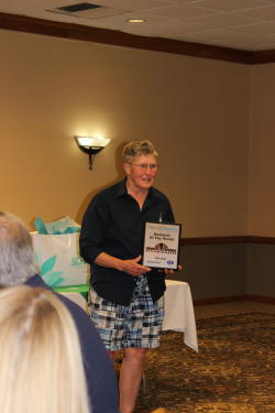 Becky Bly accepts the May Business of the Month Award on behalf of Anne Sandroni and Downtown Deli during the Chambers May Business After Hours event