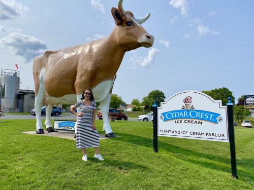 Woman standing in front of Bernice the Big Cow in Manitowoc Wisconsin