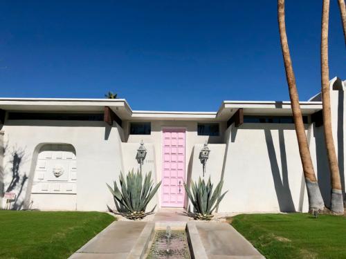 Bubblegum pink colored door at 1100 East Sierra Way
