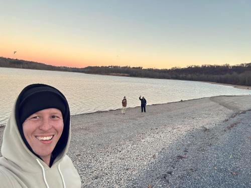 People taking a selfie during sunset at blue marsh lake in the winter