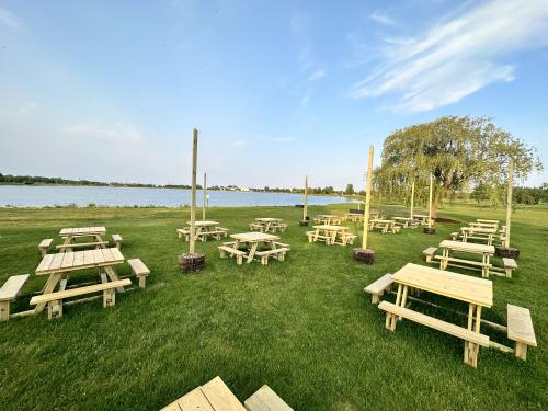 View of the Lake Andrea Beer Garden, featuring picnic tables, planters, and a view of the lake.