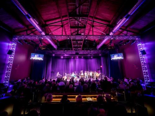 A purple-lit theatre performance of music