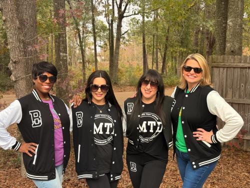 Podcast hosts Zondra and Katie pose with founders of Bad Moms That Dance marching club, Alyse Renz and Whitney Hebert.