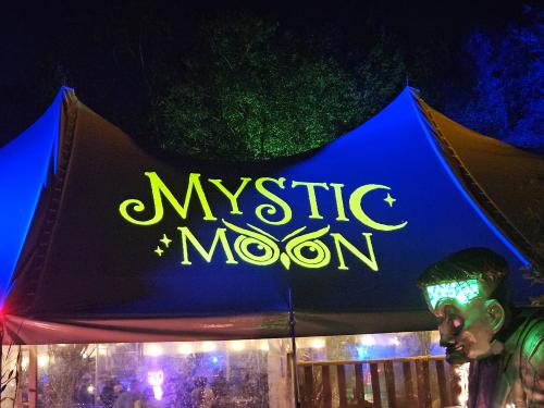 A tent displaying the name of the Mystic Moon event.
