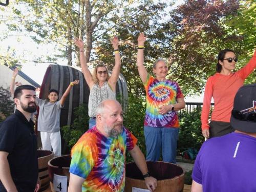 Group of people celebrating after a grape stomping competition