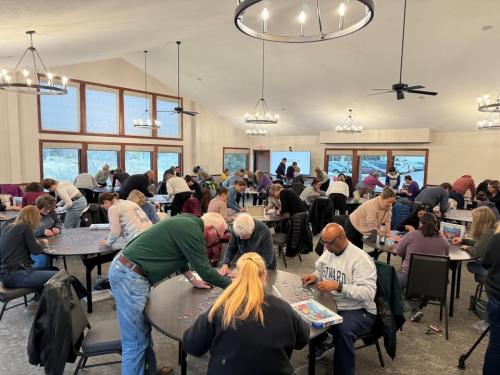 Puzzlepalooza event showing a group of attendees taking on Woodbury’s jigsaw puzzle challenge