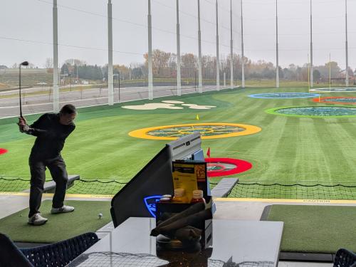 Player swinging a club at Topgolf Woodbury