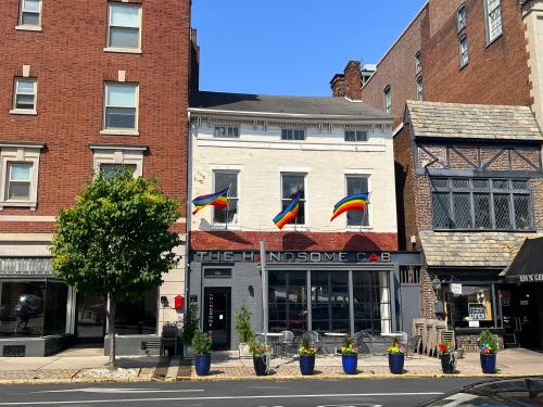 the handsome cab with pride flags displayed on their building