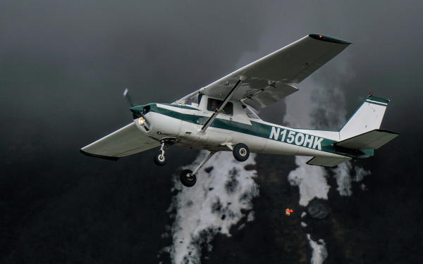 a small airplane drops a bag of flour